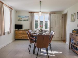 a dining room with a table and chairs at South Glebe in Axminster