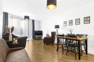 a living room with a table and a dining room at Magical - 2Bed Apartment- City Centre-Free Parking in Birmingham