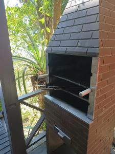 a brick oven with a cigarette on top of it at La Roca Studio 7 in Praia do Rosa