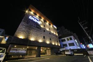 a building with a sign on it at night at DUNE45 in Suwon