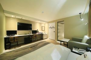 a hotel room with a bed and a desk at DUNE45 in Suwon