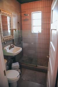 a bathroom with a shower and a sink and a toilet at Casa Mina #4 Central Rio Grande Historic District in El Paso