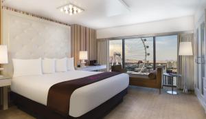 ein Schlafzimmer mit einem großen Bett und einem großen Fenster in der Unterkunft Flamingo Las Vegas Hotel & Casino in Las Vegas