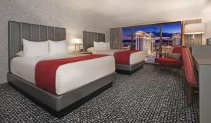two beds in a hotel room with a view at Flamingo Las Vegas Hotel & Casino in Las Vegas
