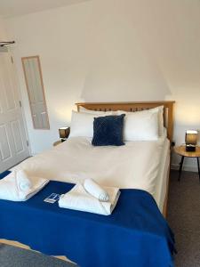 a bedroom with a bed with towels on it at Cambridge Studios and Suites by Tas Accommodations in Cambridge