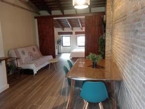 uma sala de estar com uma mesa e cadeiras e um sofá em Valencia Canyamelar Beach Apartments em Valência