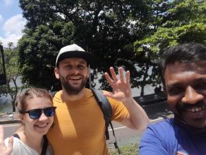 two men and a woman posing for a picture at Sigiri Lodge in Sigiriya