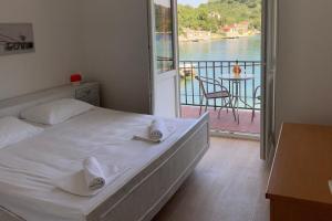 a bedroom with a bed with a view of the water at Apartments by the sea Okuklje, Mljet - 4912 in Maranovići