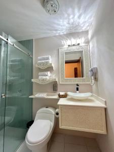 a bathroom with a toilet and a sink and a shower at Dakani Hotel Boutique NEW in Quito +38 photos