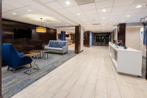 a lobby with a waiting area with chairs and a couch at Holiday Inn Express Philadelphia NE-Bensalem, an IHG Hotel in Bensalem