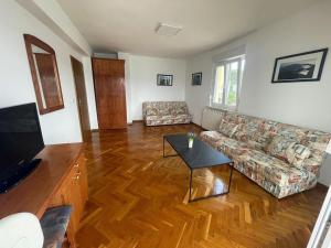 a living room with a couch and a table at Apartments by the sea Slatine, Ciovo - 1139 in Slatine