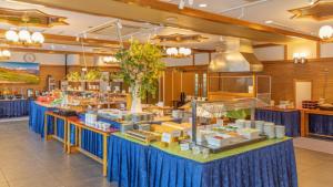 a buffet line with blue tables in a restaurant at Kyukamura Norikura-Kogen in Matsumoto