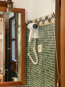 a hairdryer hanging on a wall in a bathroom at Mirador del Valle Bed & Breakfast in Eriste