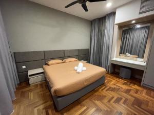 a bedroom with a bed with a teddy bear on it at LOVEly 2 bedrooms Premier Suite Vista FREE WIFI in Genting Highlands