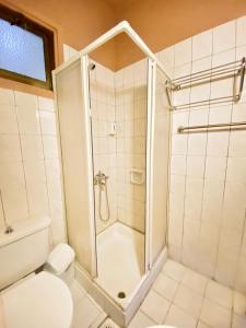 a bathroom with a shower and a toilet at Kaan Hotel & Apartment in Kérynia +7 photos