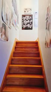 a set of wooden stairs in a room with posters at Agit Guesthouse in Seoul