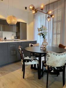 a kitchen with a dining room table and chairs at GreenKey Suite T21 in Reykjavík