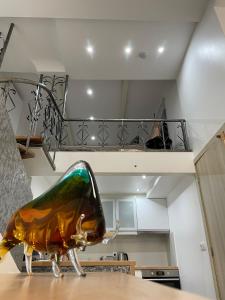 a glass animal sitting on top of a table in a kitchen at Duplex situé a 2min de la gare du nord in Brussels