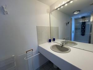 a bathroom with a sink and a mirror at Bel appartement en front de mer avec balcon, parking et équipements modernes - FR-1-361-327 in Granville +13 photos