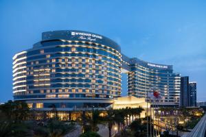 a large building with lights on in a city at Wyndham Grand Plaza Royale Xiamen - Wuyuan Bayview in Xiamen