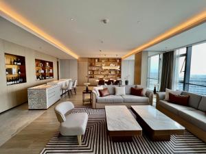 a living room with a couch and a table and chairs at Wanda Jin Xiaohe Xincheng in Taiyuan