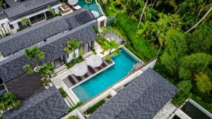 an aerial view of a building with a swimming pool at Villa Jump by BaliSuperHost in Ubud