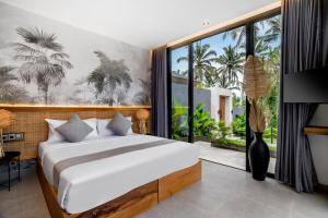 a bedroom with a bed and a large window at Villa Jump by BaliSuperHost in Ubud +12 photos