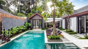 an infinity pool in the backyard of a house at Villa Jump by BaliSuperHost in Ubud