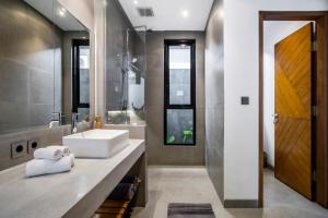a bathroom with a sink and a mirror at Villa Jump by BaliSuperHost in Ubud