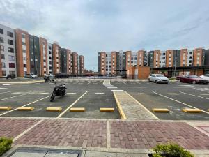 a parking lot with a motorcycle parked in it at Hermoso apartamento en jamundi con piscina y parqueadero in Jamundí +3 photos