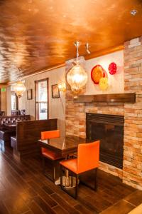 a living room with a fireplace and a table and chairs at Canyons Boutique Hotel - A Canyons Collection Property in Kanab