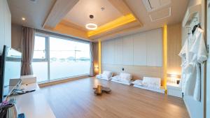 a large living room with a large window at Hotel The One in Yeosu