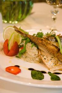 a plate of food with fish and rice at Pokoje Przy Stoczku in Białowieża +17 photos