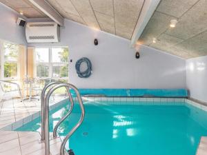 a swimming pool with blue water in a building at Three-Bedroom Holiday home in Hemmet 30 in Humble