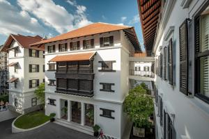 an overhead view of a white building with a brown roof at Bella Nara Hotel Chiang Mai in Chiang Mai