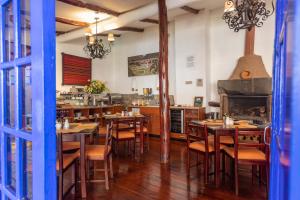 a restaurant with wooden tables and chairs and a kitchen at Casa Andina Standard Cusco San Blas in Cusco