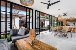 a living room with a couch and a table at Villa Hammock by BaliSuperHost in Ubud