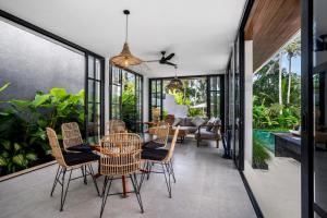 an indoor patio with a table and chairs at Villa Hammock by BaliSuperHost in Ubud