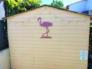 a pink flamingo painted on the side of a garage at Maison T2 proche mer jardin et parking securise in Six-Fours-les-Plages