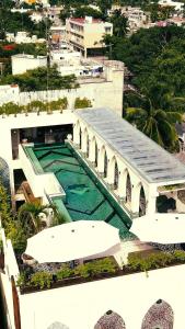 a large swimming pool in the middle of a city at Layla Tulum - Adults Only in Tulum