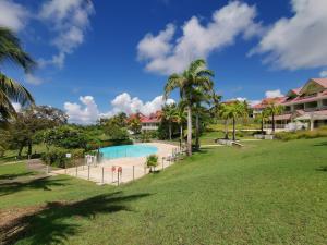 a view of the pool at a resort at Studio Coco Zen in Sainte-Anne