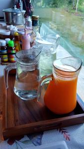 a tray with two glasses of orange juice on a table at Lys I dalen resort&camping in Khao Kho