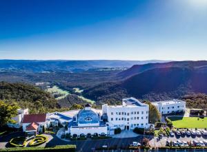 an aerial view of a building with mountains in the background at Hydro Majestic Blue Mountains in Medlow Bath