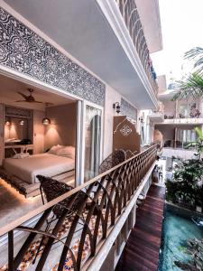 a bedroom with a bed and a balcony with a mirror at Layla Tulum - Adults Only in Tulum