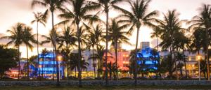 a group of palm trees in front of a building at Sobe Apartments in Miami Beach