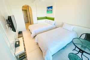 Postel nebo postele na pokoji v ubytování Hamdeok Beach Stay Jeju