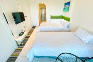 Postel nebo postele na pokoji v ubytování Hamdeok Beach Stay Jeju