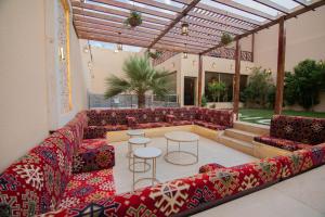a living room with a couch and a table and chairs at Abant Chalets in Riyadh