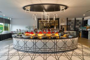 a kitchen with a table with wine glasses on it at Travelodge Ipoh in Ipoh +55 photos