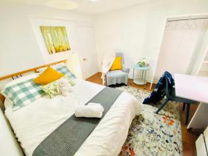 a bedroom with a bed with a stuffed animal on it at Sunrise Tree BnB - your Home away from home in Toronto